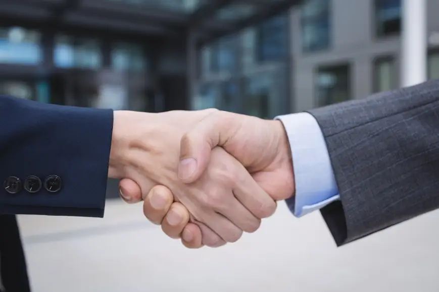 businesspeople-shaking-hands Owner Neil Hallinan